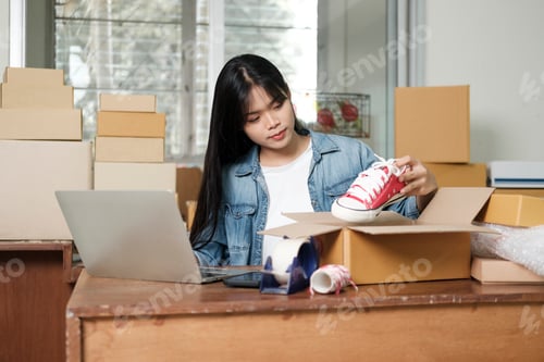 Preview: Online business owner preparing product to customer.