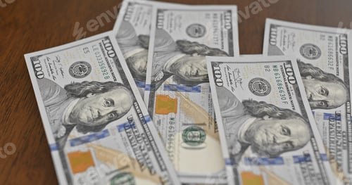 Preview: United States One Hundred Dollar Bills on Table