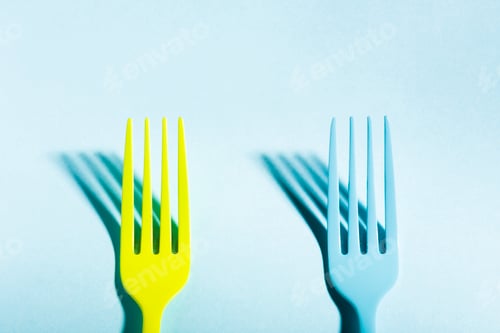 Preview: Yellow and blue forks on blue background