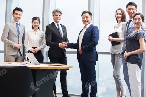Preview: Chinese businessmen shaking hands in meeting room