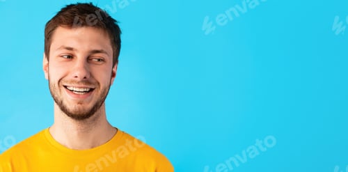 Preview: Smiling confident man looking at copy space on blue background