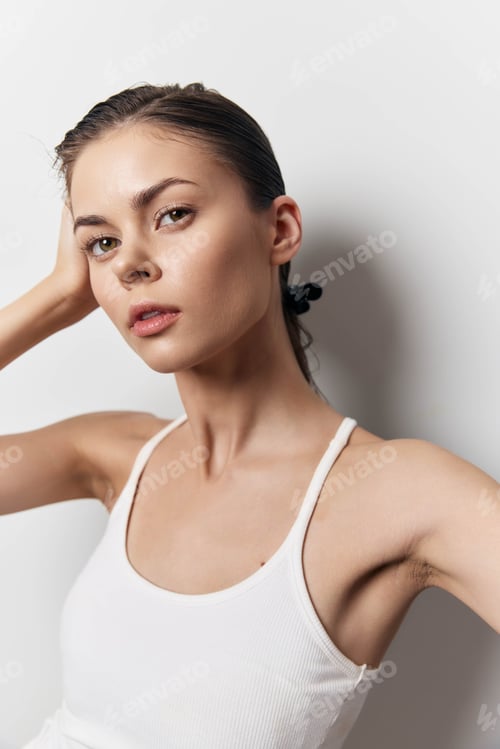 Preview: Portrait of a young woman with natural beauty, styled hair, and a minimalist look against a soft