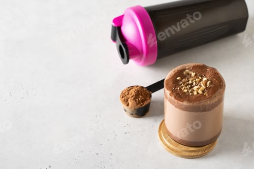 Preview: Protein chocolate cocktail drink in glass with powder and scoop
