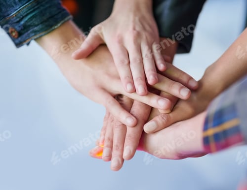 Preview: Shot of a group of unidentifiable friends making a pact by putting their hands in a pile