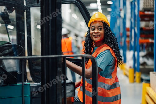 Preview: African american woman warehouse worker beside forklift in industrial space