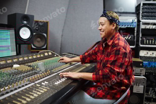 Preview: Woman Working at a Mixing Console in Studio