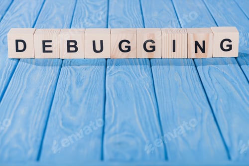 Preview: close up view of debugging word made of wooden blocks on blue tabletop