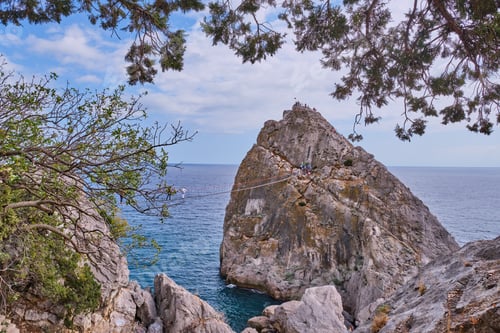 Preview: Rock Diva, Black sea coast, town Simeiz, Crimea. People walk on suspension bridge, climb to top.