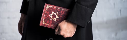 Preview: panoramic shot of young jewish man holding tanakh