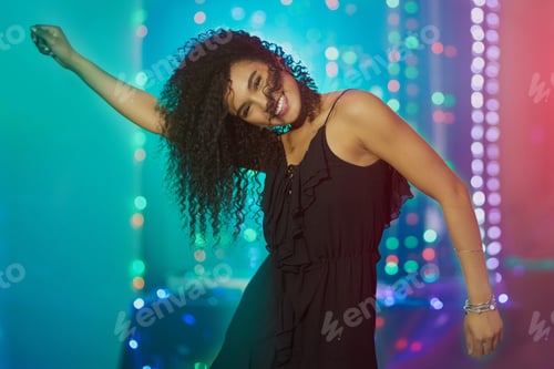 Preview: Get down tonight. Shot of a beautiful young woman dancing in a nightclub.