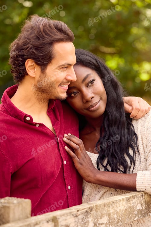 Preview: Loving Mixed Race Couple Leaning On Fence On Walk In Countryside