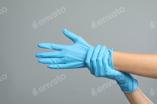 Preview: Doctor wearing medical gloves on grey background, closeup