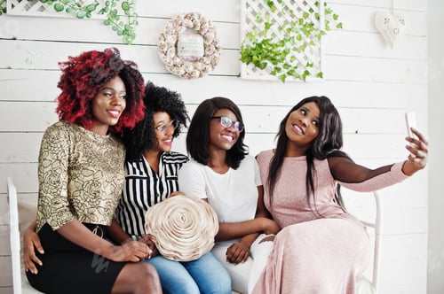 Preview: Group of friends sitting for a selfie indoors