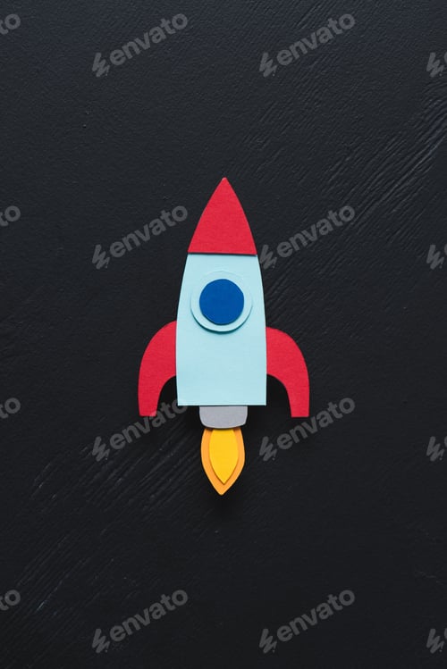 Preview: top view of flying paper rocket on black background, setting goals concept