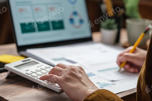 Preview: close up hand using calculator calculate tax and budget of project at home