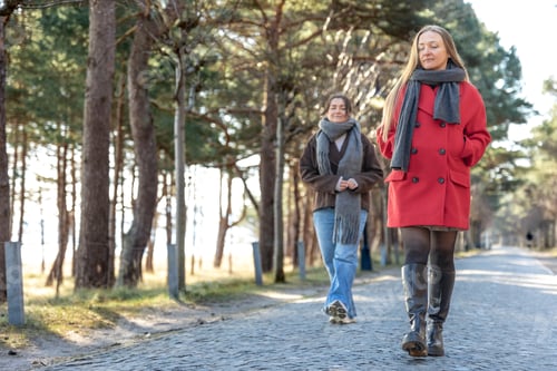 Preview: Two women walking in the park. Friends walking on a path in the park. Nature.