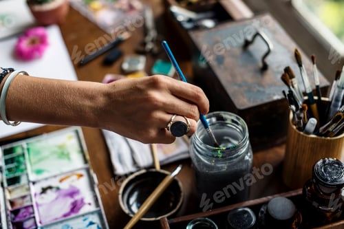 Preview: Artist Prepares Paintbrush for Creative Painting Session