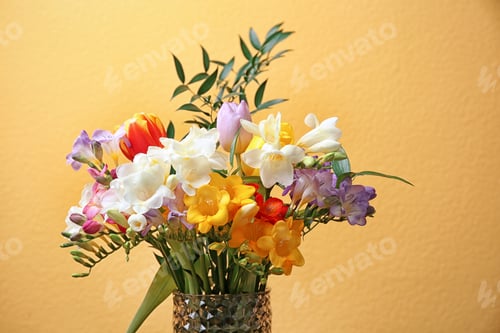 Preview: Glass vase with beautiful freesia on color background
