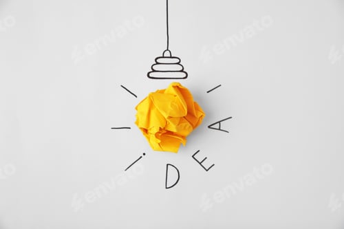 Preview: Composition with crumpled paper as lamp bulb and word IDEA on white background