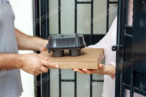 Preview: Food delivery service man with pizza cardboard delivering food to customer at doorway.