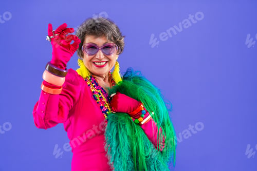 Preview: Happy and funny senior old woman on colorful background