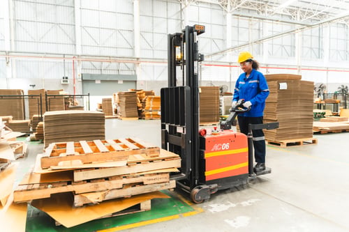 Preview: paper cardboard manufacture factory concept, industry worker person working with machine