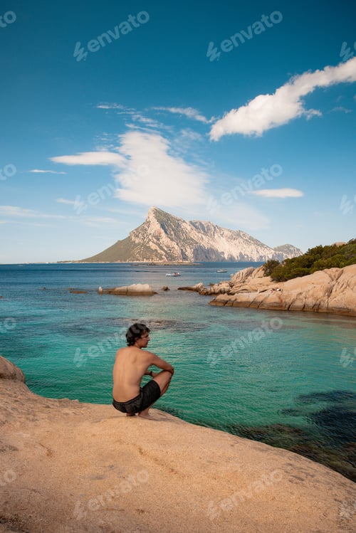 Preview: Tourist enjoying breathtaking view of tavolara island in sardinia, italy