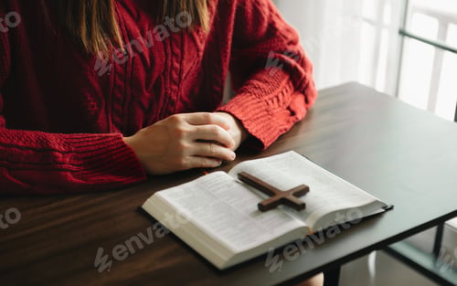 Preview: Woman praying on holy bible in the morning.Woman hand with Bible praying. Christian life crisis