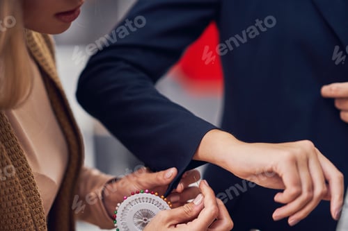 Preview: Fashion designer assisting the customer in clothes boutique