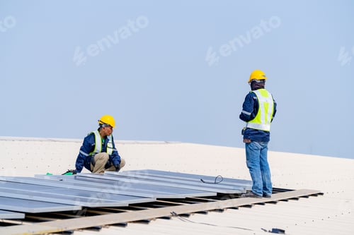 Preview: workers installing solar panels, for efficient energy on rooftop