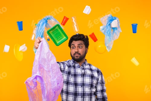 Preview: Plastic recycling problem, ecology and environmental disaster concept - Confused Indian man holding