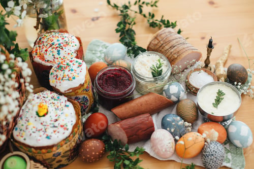 Preview: Easter modern eggs, cake, ham, beets, butter in rustic basket decorated with green buxus branches