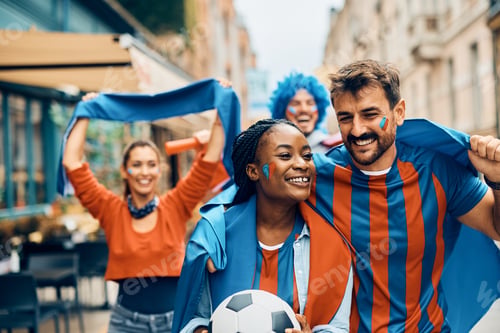 Preview: Happy couple of soccer fans celebrating their team's victory during the world championship.