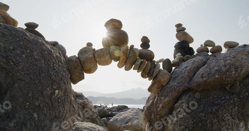 Preview: Arch of pebbles in balancing on the sea coast