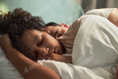 Preview: Young Adult Multiethnic Couple Sleeping Peacefully Together in Bed