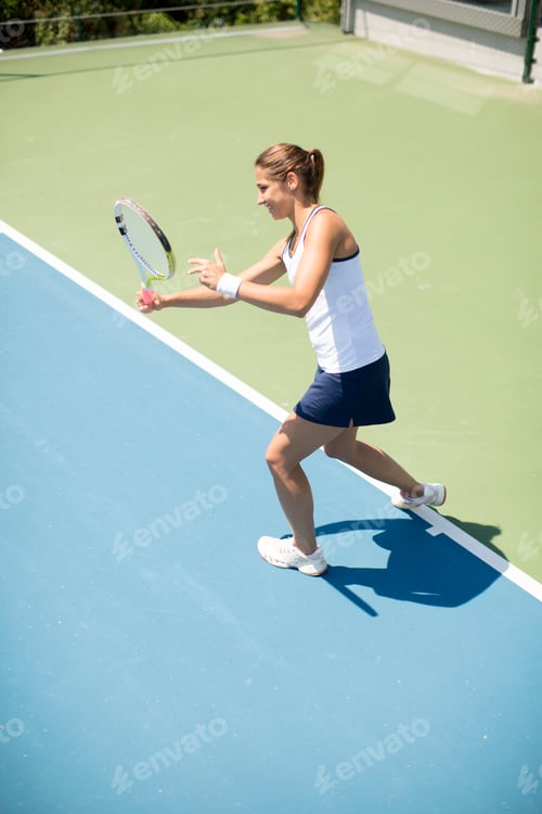 Preview: Young woman playing tennis