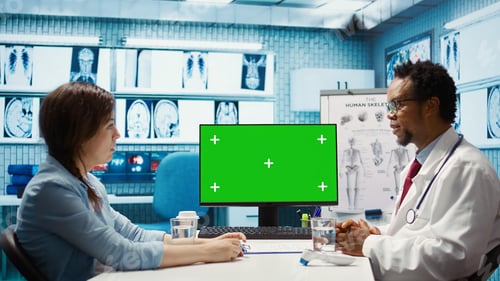 Preview: African american medical expert looking at copy space screen with a patient