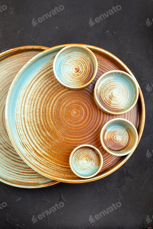 Preview: top view brown plates with little plates on dark background color table glass meal kitchen cutlery