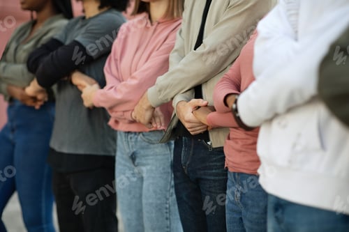 Preview: Group of protestors standing together holding hands in picket