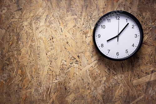 Preview: Clock watch at wooden chipboard of wall surface background