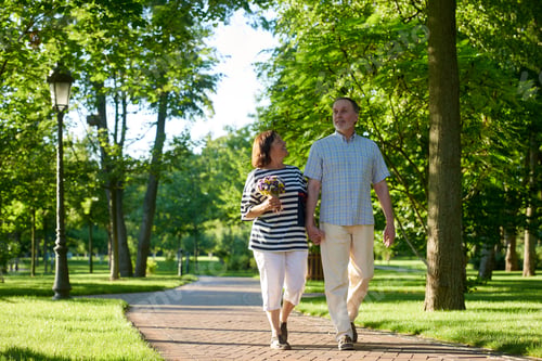 Preview: Shot of walking mature caucasian couple in the park.