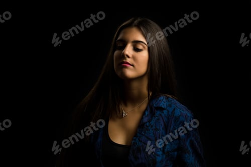 Preview: young brunette girl with long straight hair posing, black background