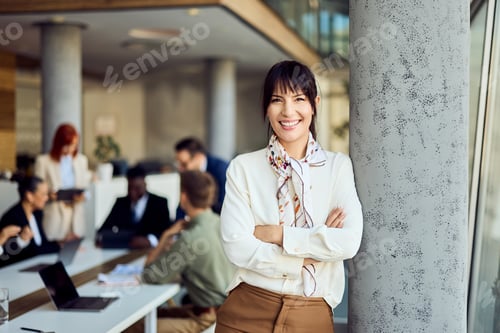 Preview: Confident Businesswoman Smiling in Modern Office with Team Working in Background