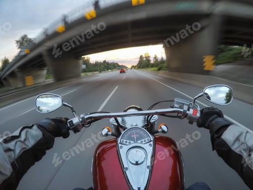 Preview: Riding a motorcycle during a vibrant sunset