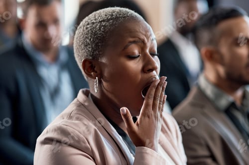 Preview: Shot of a an exhausted businesswoman yawning during a conference in a modern office