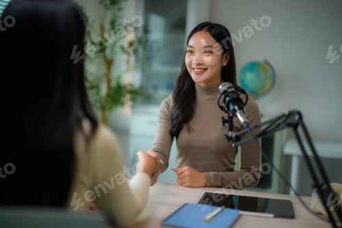 Preview: Asian woman guest shaking hands podcast host