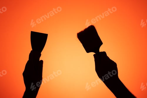 Preview: Hands holding painter's tools. Brush and spatula.