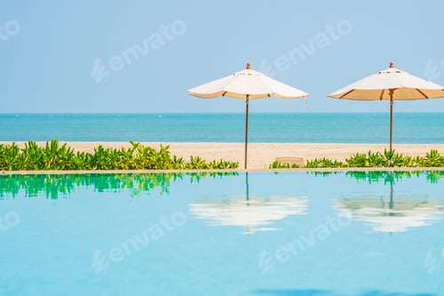 Preview: Umbrella and chair around outdoor swimming pool in hotel resort