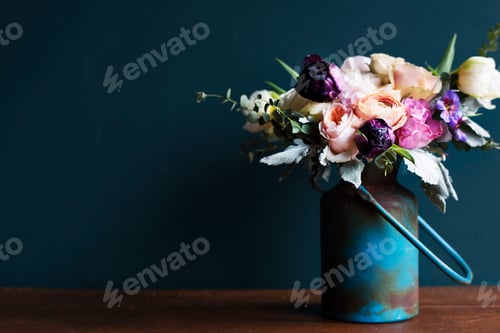 Preview: Various fresh flowers arrangement in metalic vase on wooden tabl