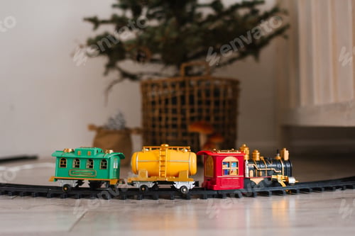 Preview: Toy train with a yellow tank car and red caboose